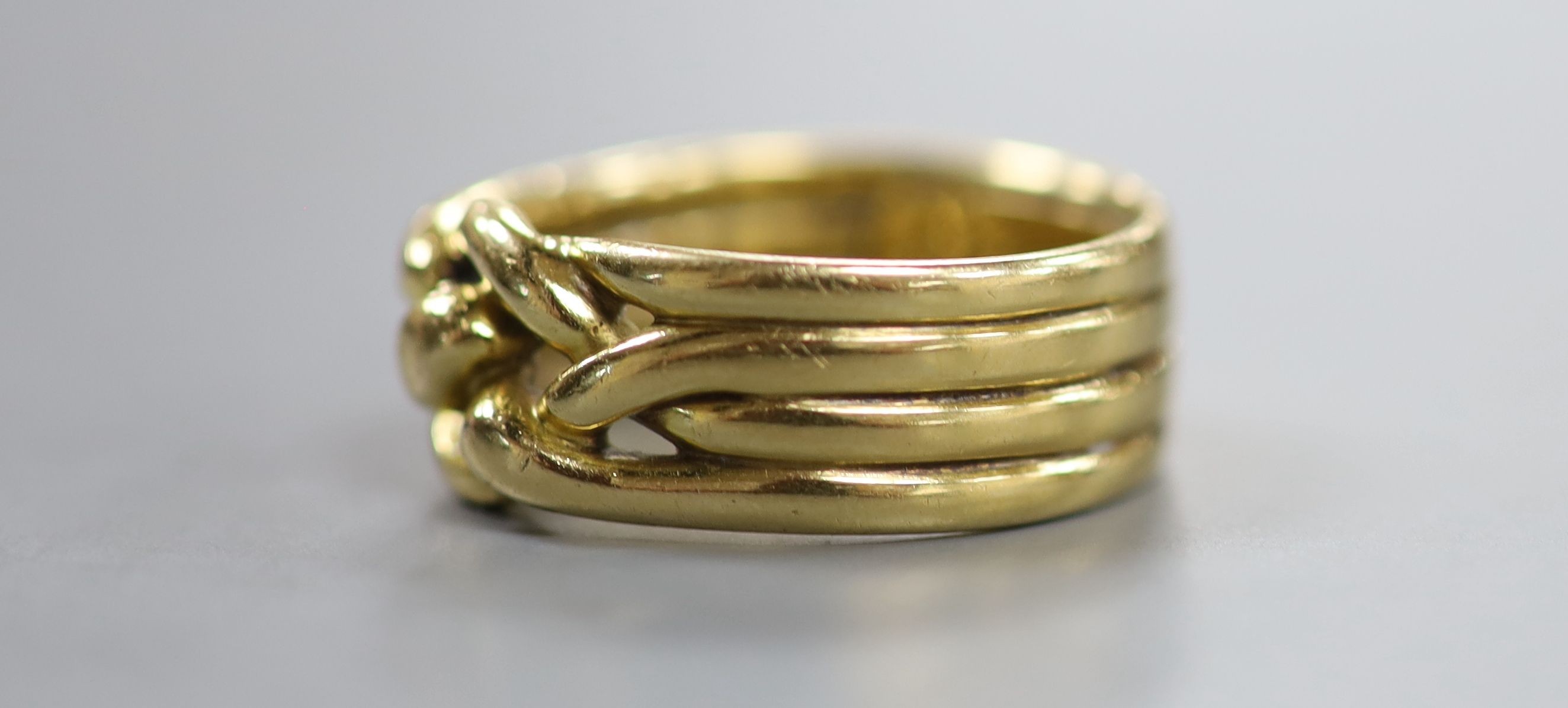 A Victorian yellow metal quadruple band knot ring, inscribed 'Joseph Massie August, 1883' size P/Q, 12.5 grams.